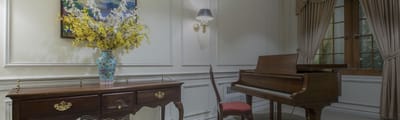 Cozy interior with a piano and decorative flowers