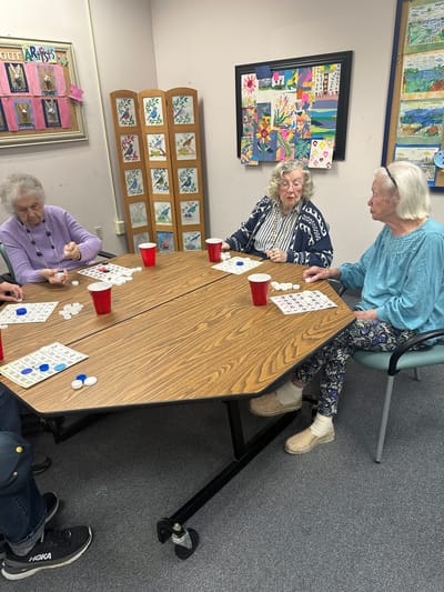 Residents enjoying a game of bingo around a table