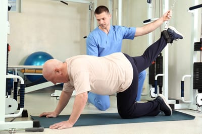 Physical therapy session with a resident and staff member