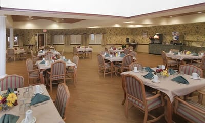 Dining room with tables set for residents