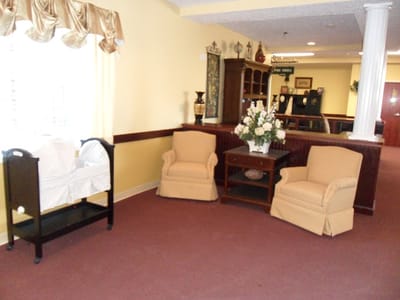 Cozy lobby area with chairs and floral arrangement