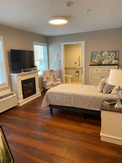Cozy resident room with a fireplace and seating area