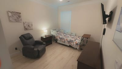 Private resident room with bed and chair