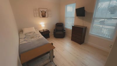 Private resident room with bed and chair