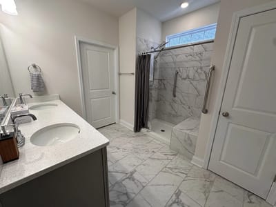 Well-lit bathroom with modern fixtures and marble tiles