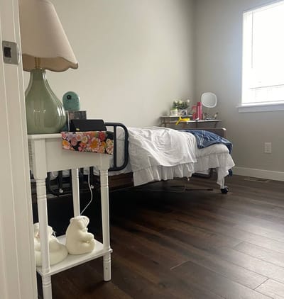 Cozy resident room with a bed and lamp