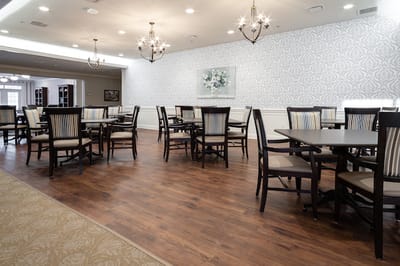 Dining room with tables and chairs in a bright setting