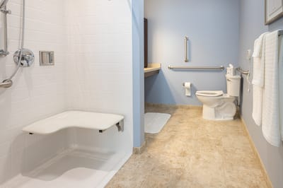 Accessible bathroom with grab bars and shower bench