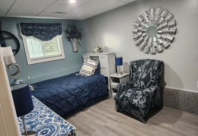 Private resident room with a bed and seating area