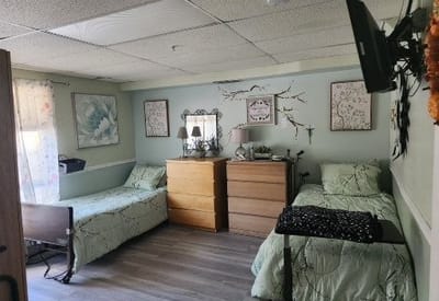Cozy shared resident room with two beds and decor