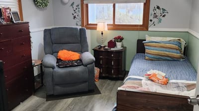 Cozy resident room with a recliner and bed