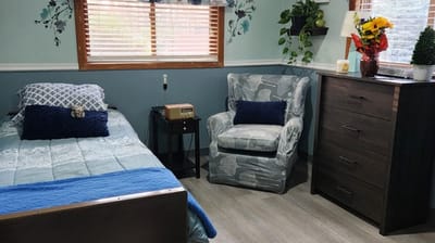 Cozy private room with a bed and chair