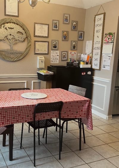 Cozy dining area with a checked tablecloth and wall decor