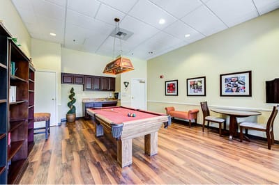 Interior room with a pool table and seating