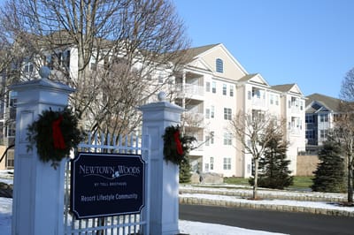 Exterior view of Newtown Woods facility with signage