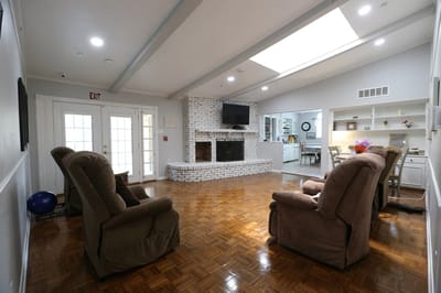 Bright common area with seating and a fireplace