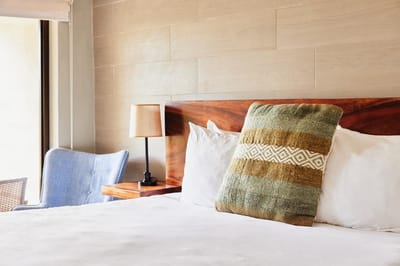 Cozy bedroom setup with a green pillow on a bed
