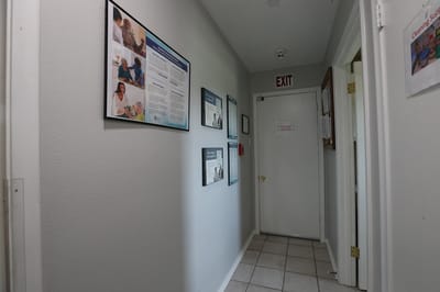 Hallway with informational posters and an exit sign