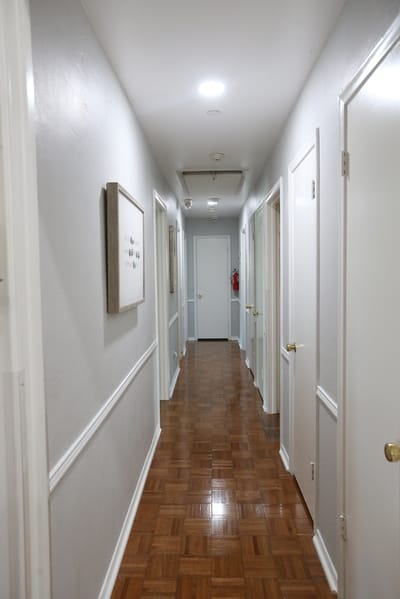 Interior hallway with doors and wooden flooring
