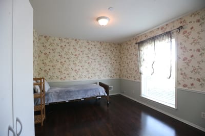 Bright, floral-themed private resident room
