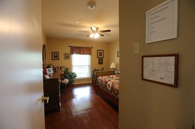 A cozy resident room with a bed and window