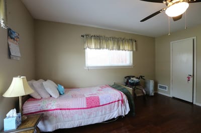 Cozy resident room with bed and lamp