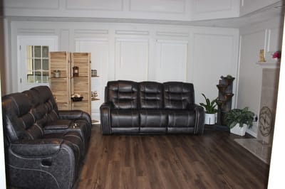 Comfortable lounge area with black sofas and plants
