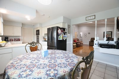 Bright common area with a dining table and living room visible