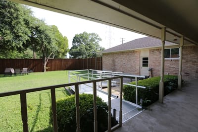 Outdoor space with a grassy area and seating