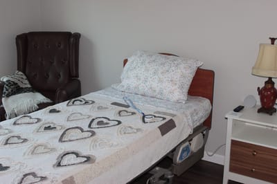 A private resident room with bed and seating area