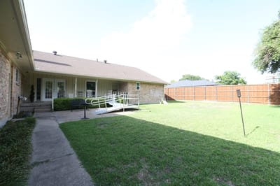 Outdoor space with grassy area and accessible ramp
