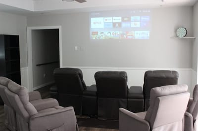 Seating area with projector and screen in common room