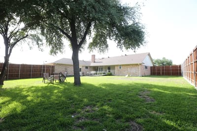 Spacious outdoor area with grass and seating