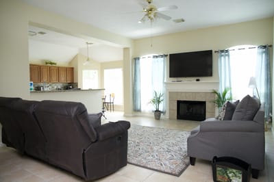 Bright common area with seating and a TV