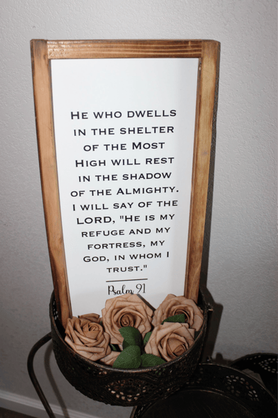 A decorative quote sign with faux roses