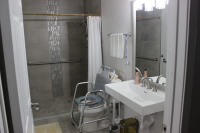 Accessible bathroom with grab bars and shower