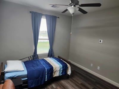 A private resident room with a bed and window