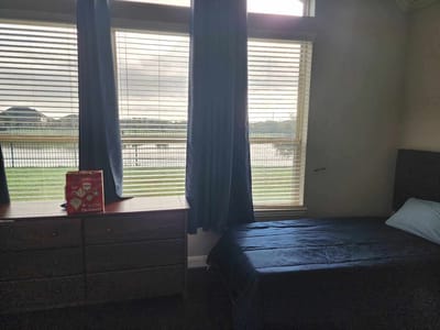 A room with a bed and view of outdoor scenery
