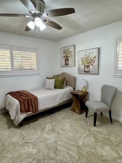 A bright and inviting resident room with a bed and decor