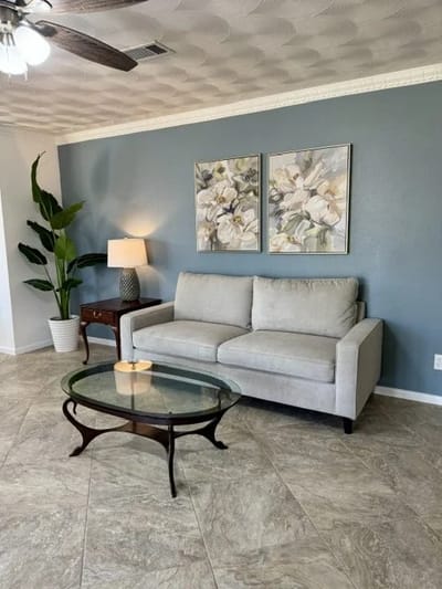 Bright common area with a couch and decor