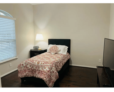 Cozy private room with a bed and lamp