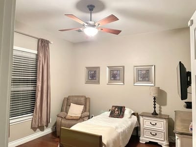 Cozy assisted living room with a bed and comfortable chair