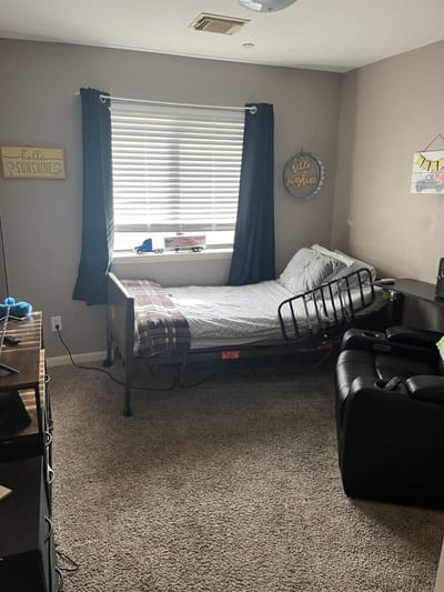 A private resident room with bed and furniture