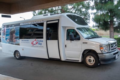 Facility transport van with logo visible