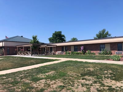 Exterior view of Wilber Care Center with garden and walkways