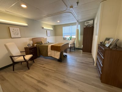 A private resident room with bed and furnishings