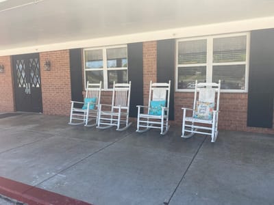 Rocking chairs on a porch outside the facility