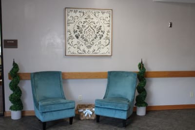 Seating area with decorative chairs and wall art