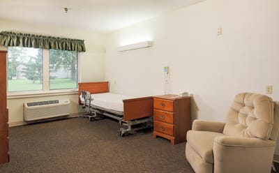 Private resident room with bed and chair