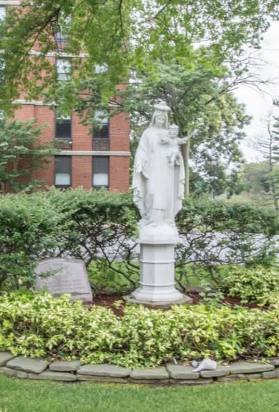 Statue in landscaped outdoor area of facility.